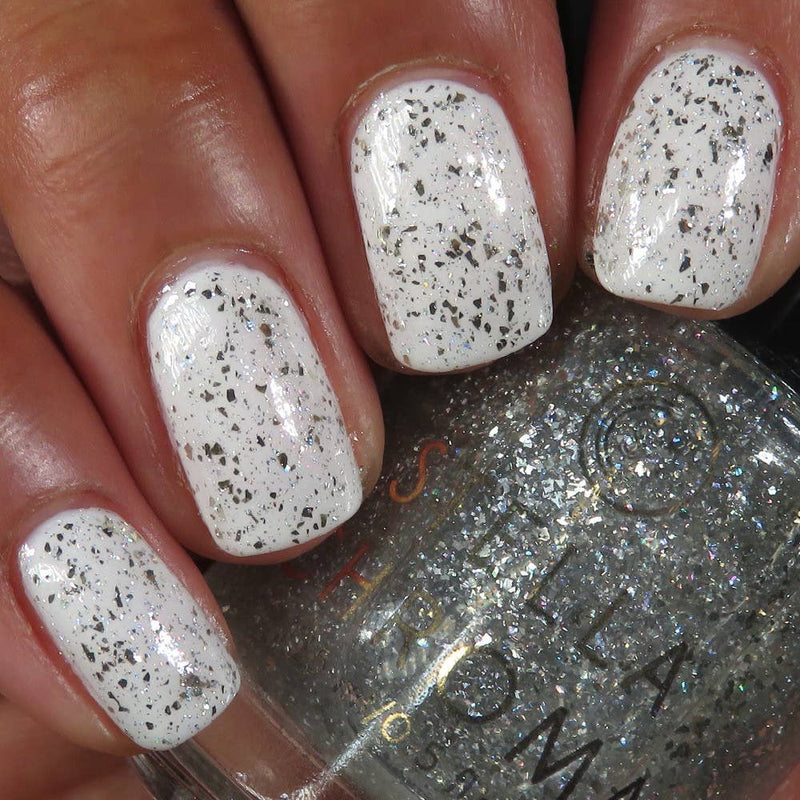 tangled tinsel is used over a white nail polish for an added sparkle